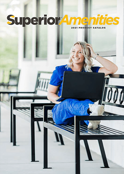 A woman sitting on top of a bench with her laptop.