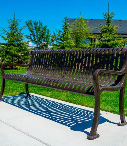 A bench sitting on top of a cement slab.