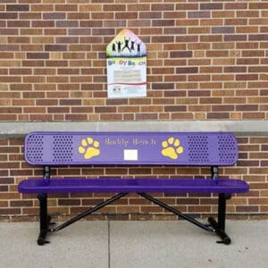 A purple bench with yellow paw prints on it.
