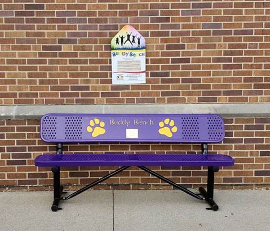 A purple bench with yellow paw prints on it.