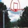 Outdoor basketball hoop near playground.