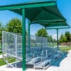 Green shaded bleachers at park.