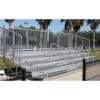 Aluminum bleachers with railings outdoors.
